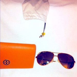 Tory Burch orange/gold sunglasses.